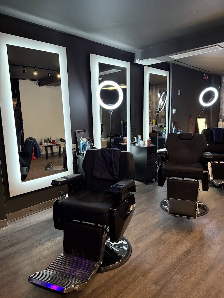 Barber chairs and illuminated mirrors inside Canvas