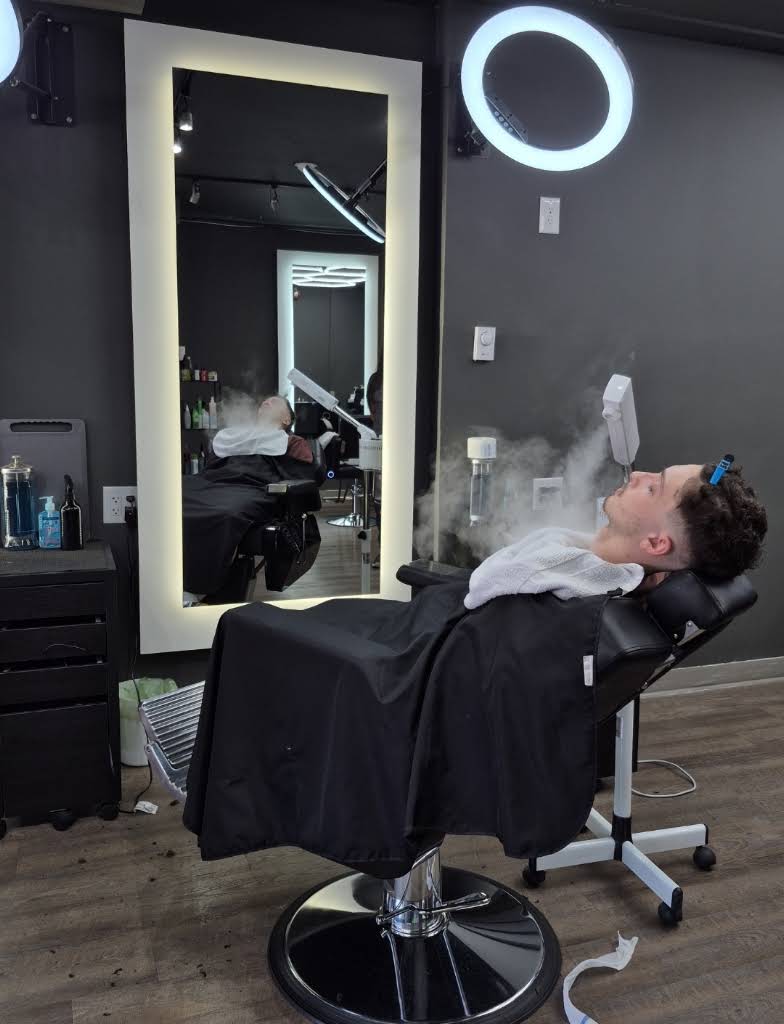 A client enjoying a facial steam treatment at Canvas